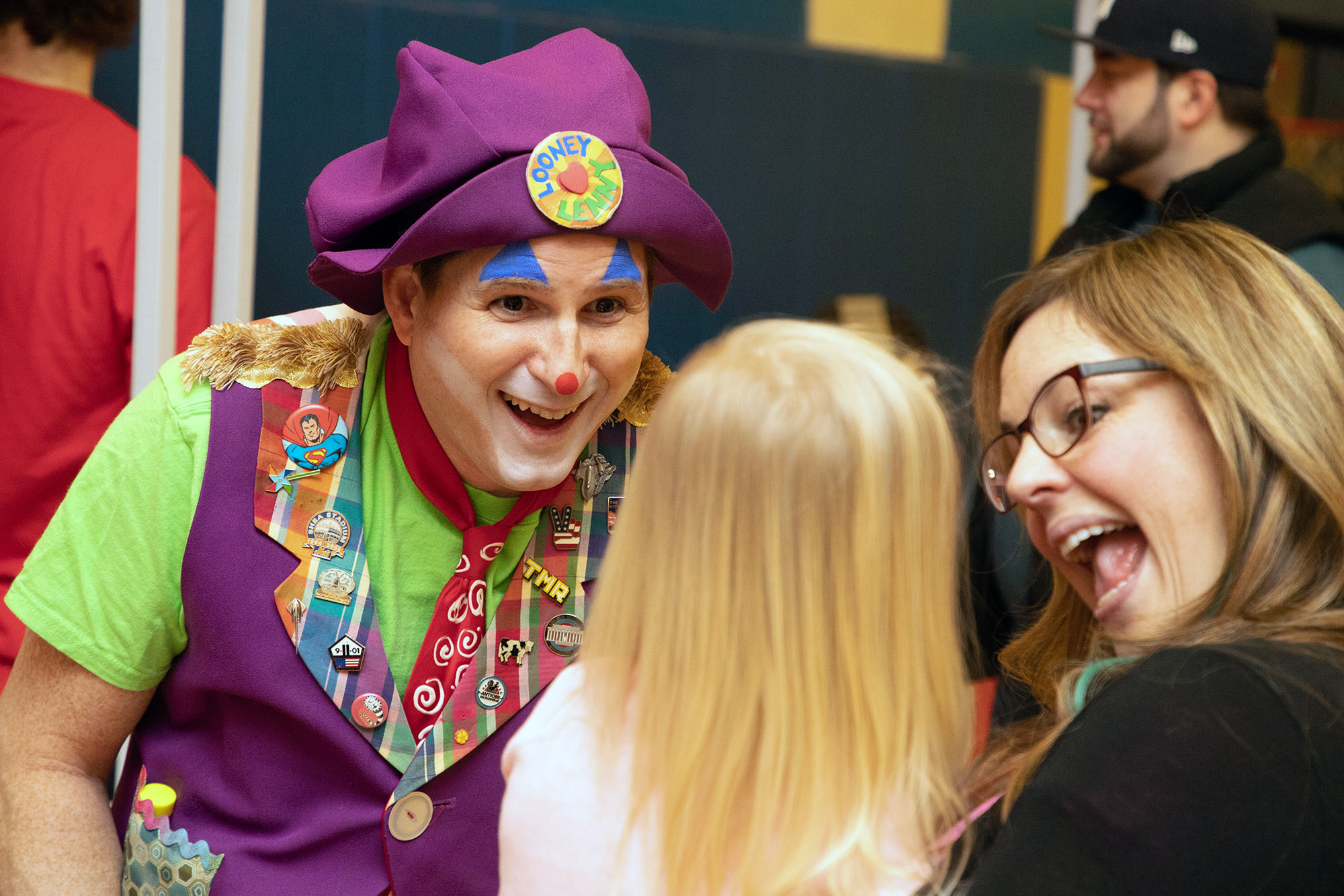 A person dressed as a clown at Maria Fareri Children's hospital greets a little girl and her mother during a fun event