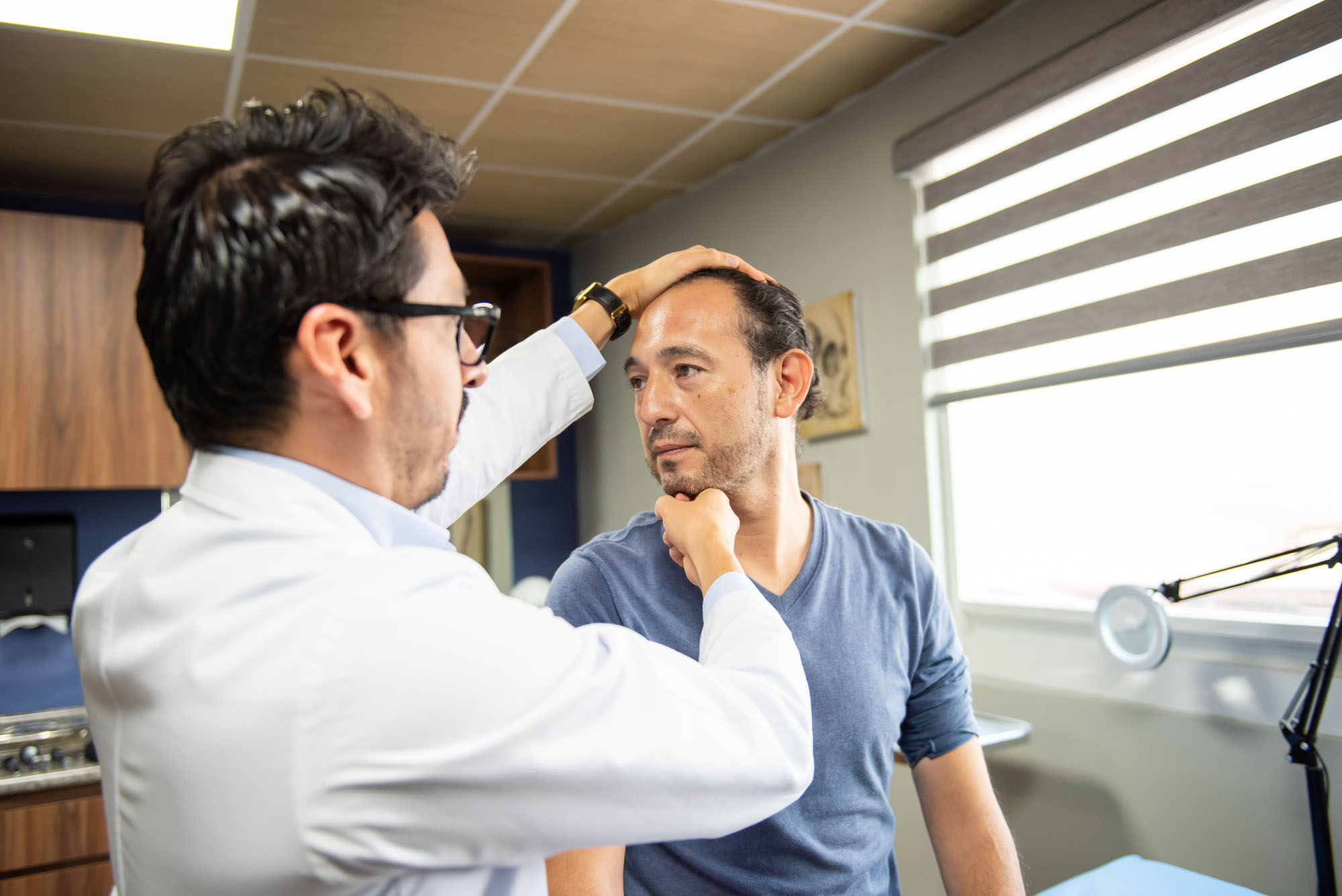 Neurosurgeon attending to male patient