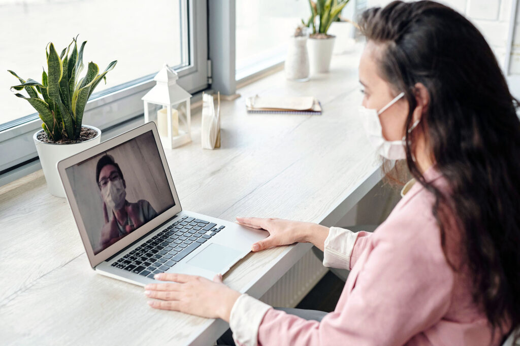 A woman has a virtual consultation with her doctor