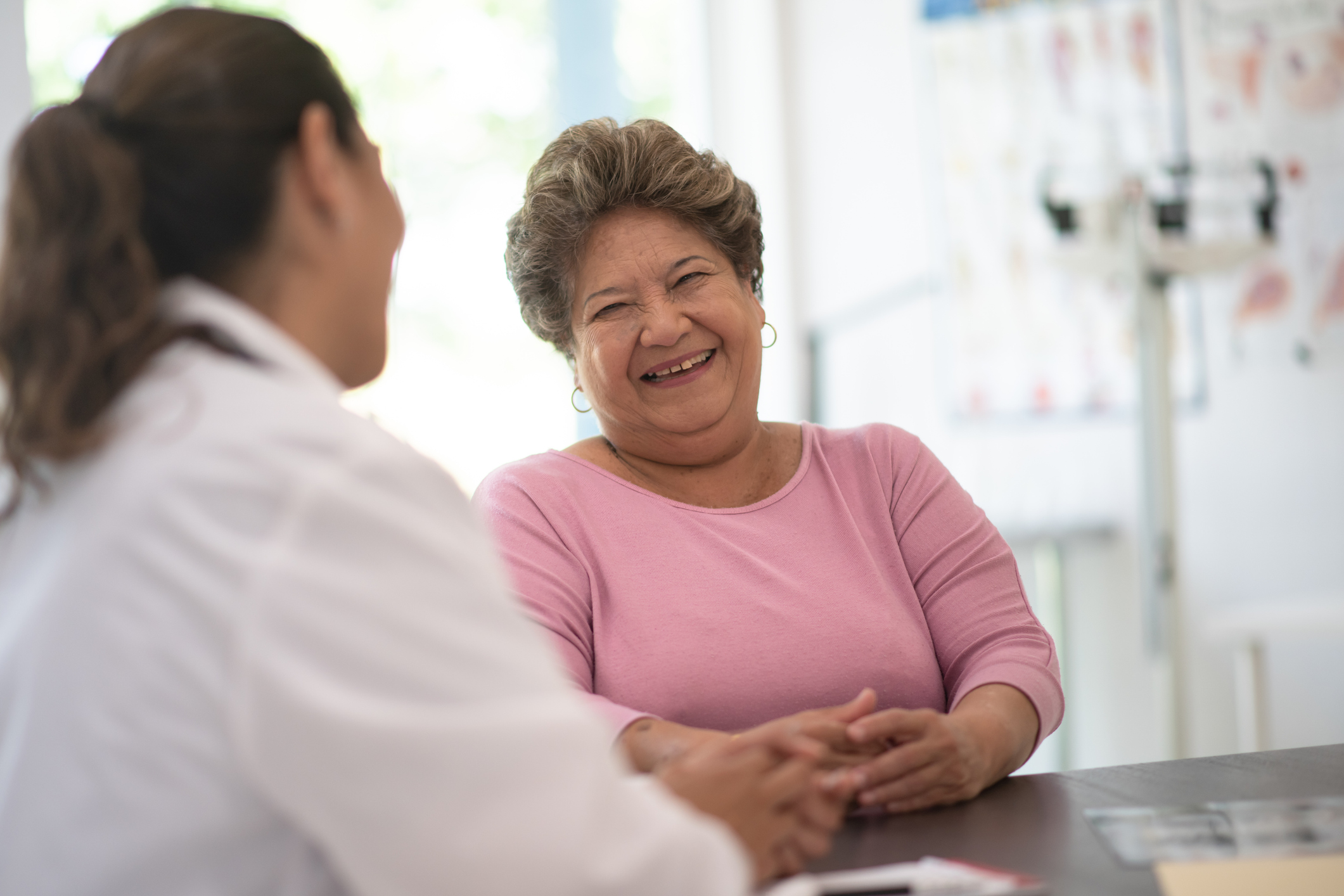 Older woman speaking and consulting with the doctor about her concerns