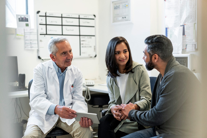 A couple consulting with their doctor in a medical office