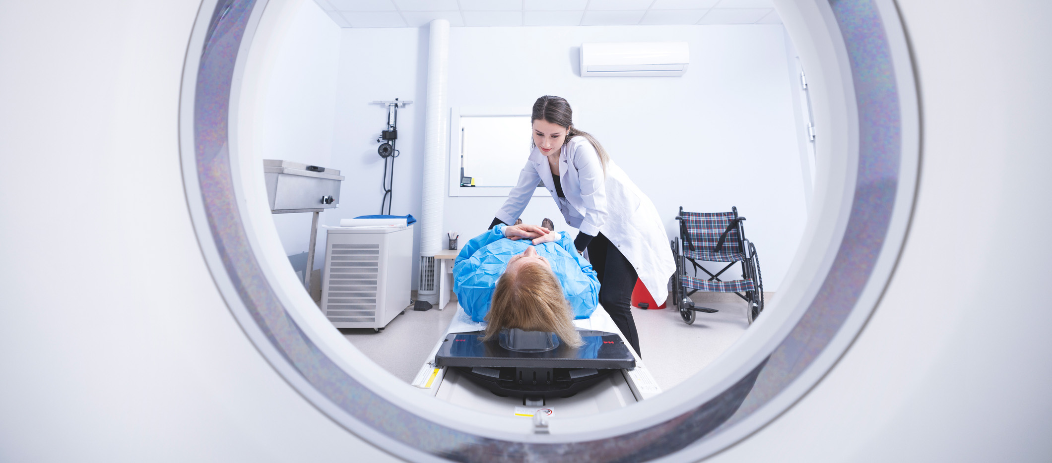 Cancer treatment in a modern medical private clinic or hospital with a linear accelerator. Professional doctors team working while the woman is undergoing radiation therapy for cancer