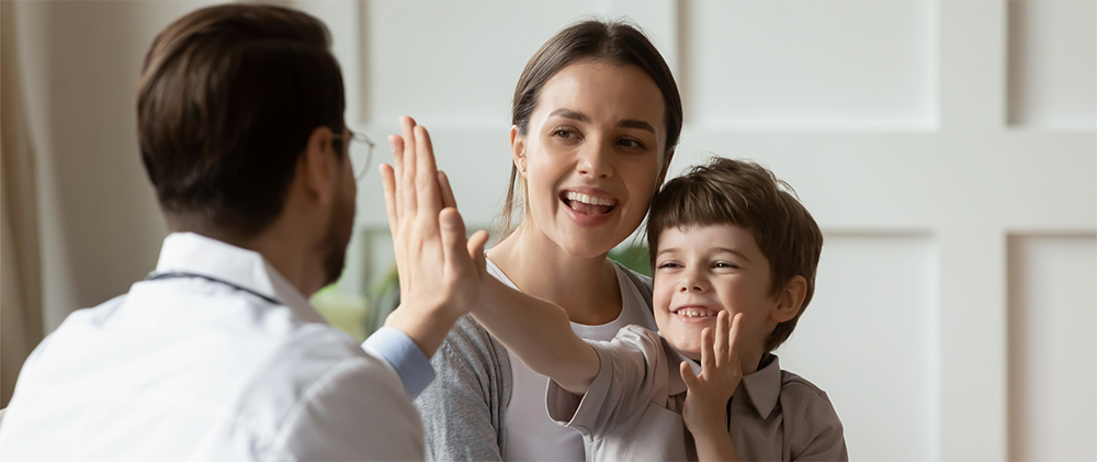 pediatrician with child, high-fiving