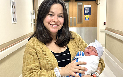 Rachel Trapanese holding daughter in hospital hallway